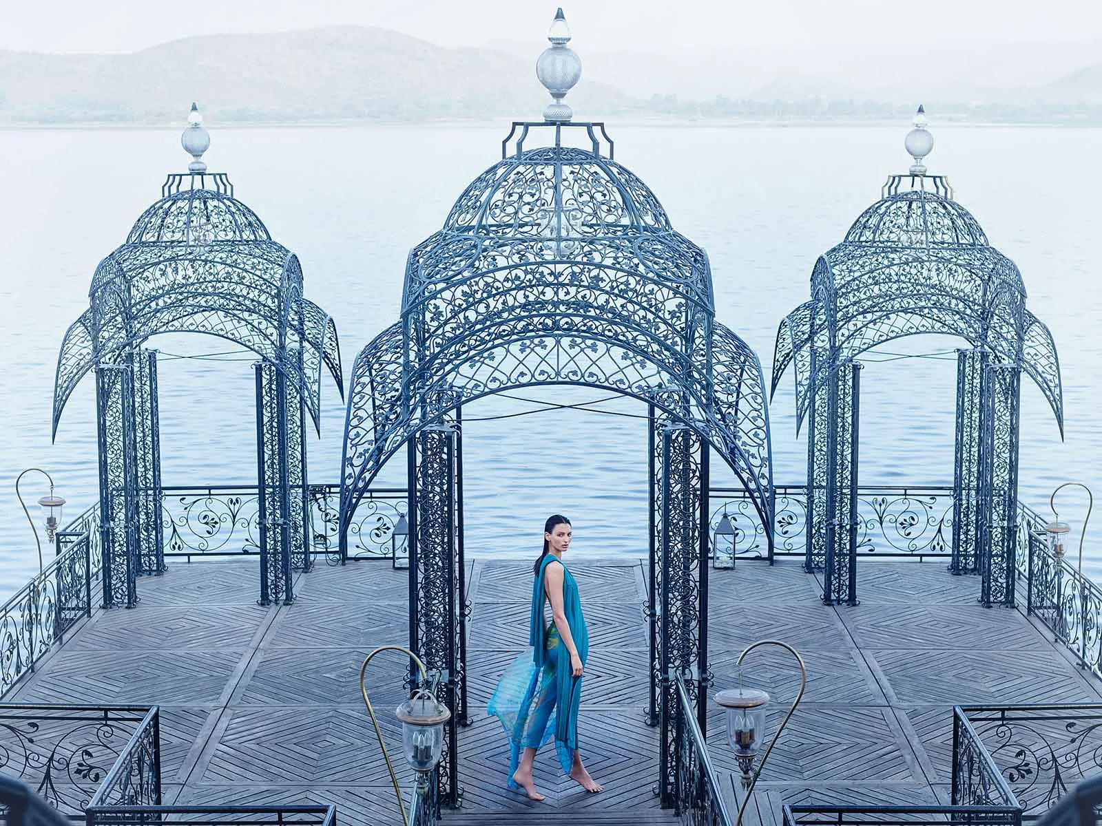An Aveda campaign image of a woman in a lakeside pavilion