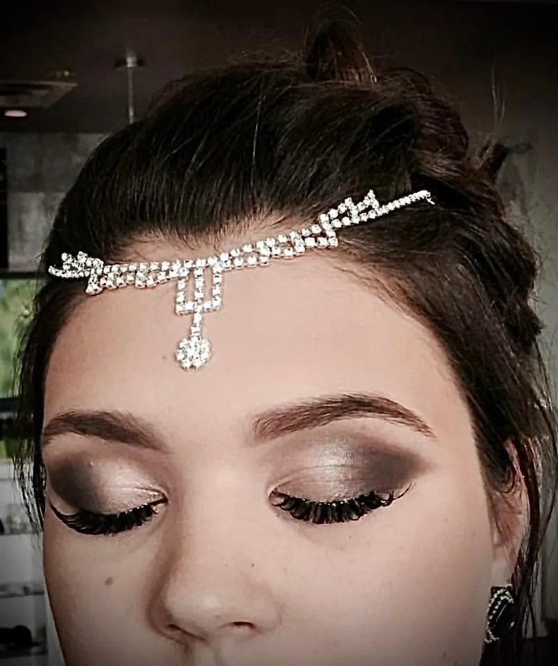 Bridal makeup with a jewelled headpiece