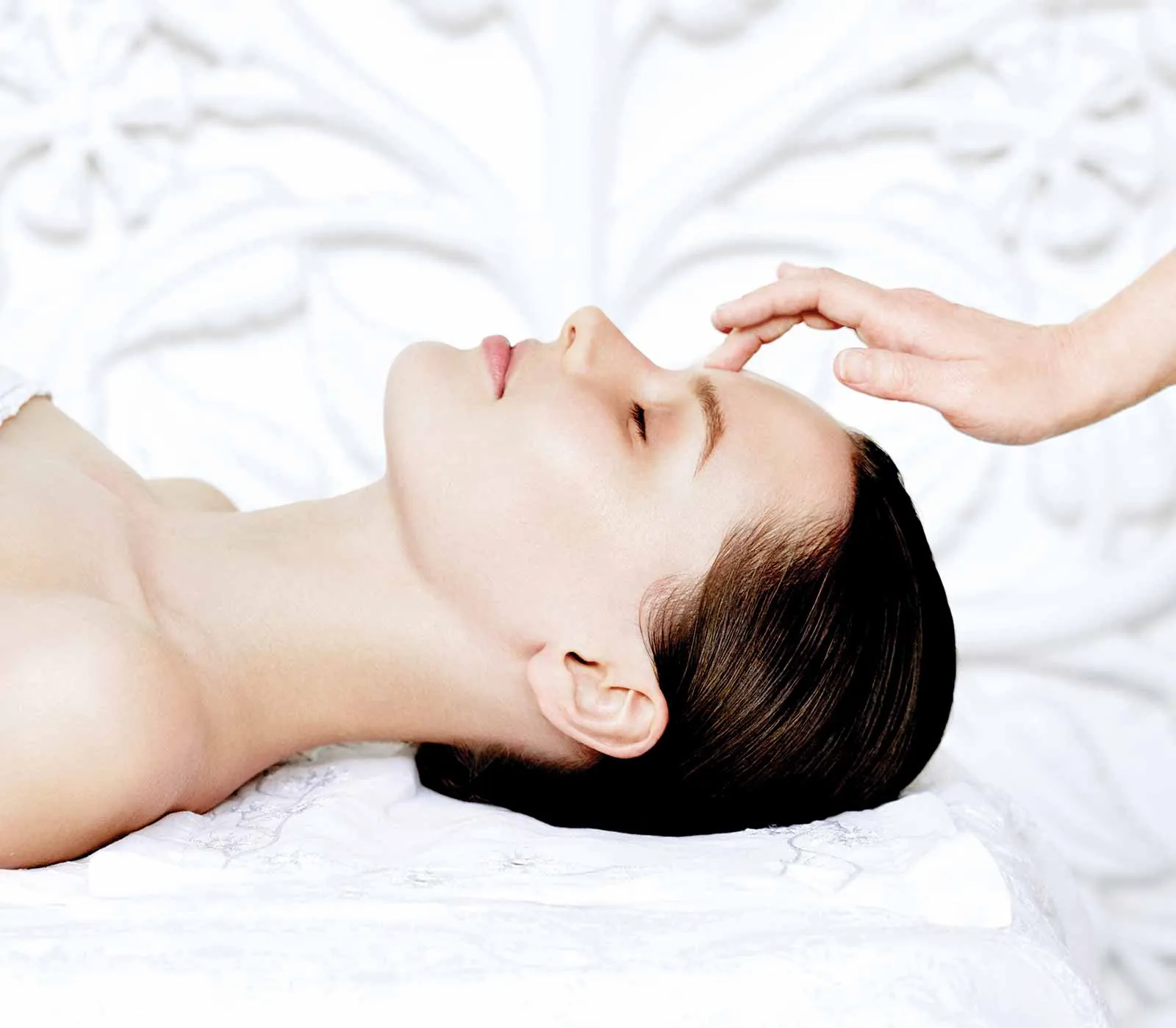 A guest relaxing during a facial